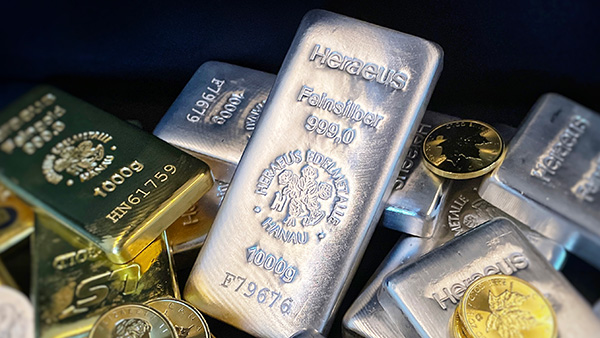 Image: Gold and silver bullion bars stacked against each other. 